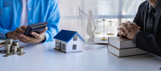 Real estate concept - judge and lawyer at auction with house model or lawyer with judge hammer to offset house insurance