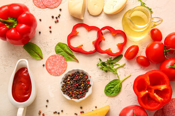 Different ingredients for preparing pizza on light background