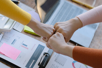 Business people shaking hands and finishing up meeting at desk in office. © SOMKID