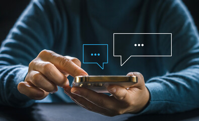 Human hand using smartphone typing Live chat chatting and social network concepts, chatting conversation working at home in chat box icons pop up. Social media marketing technology concept