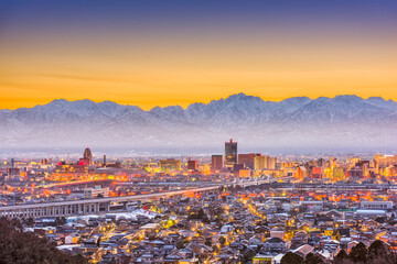 Toyama City, Japan downtown skyline with background mountains at dawn.