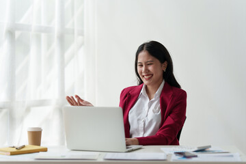 Smiling Asian Accountant person analyze financial report and studies annual figures, analyzes profits