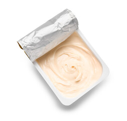 Plastic container with tasty cream cheese on white background