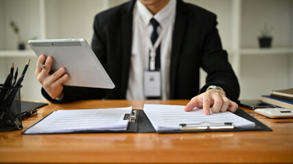 Cropped image of a professional businessman or male banker is working on his task at his desk