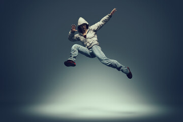 Obraz na płótnie Canvas Hip hop dancer jumping and performing some of his dance. This is a 3d render illustration