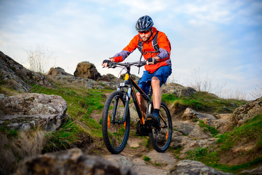 Cyclist Riding the Mountain Bike on the Beautiful Spring Rocky Trail. Extreme Sport Concept