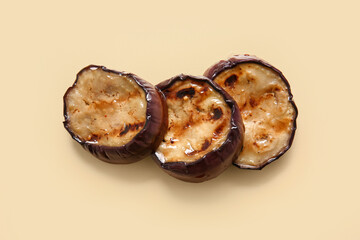Delicious grilled eggplants on beige background