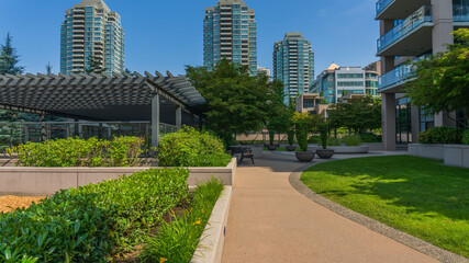High-rise residential buildings overlooking the calm of an urban garden in Burnaby, BC, Canada. © Andrew