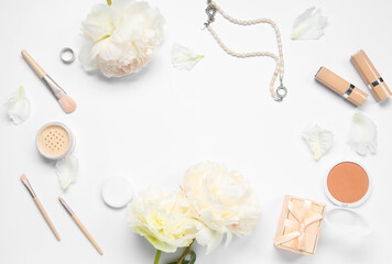 Fototapeta na wymiar Frame made of female accessories, cosmetics and beautiful peony flowers on white background