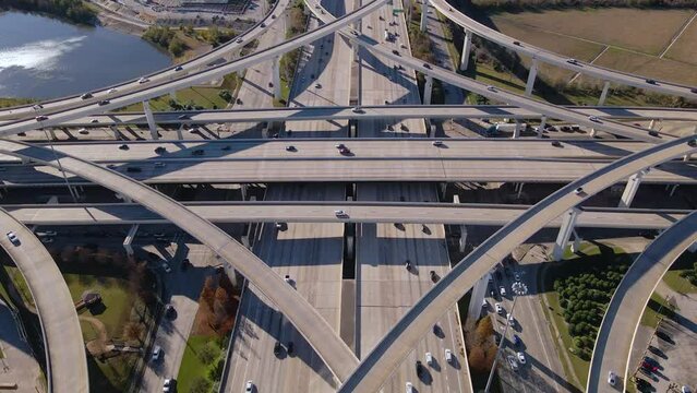 Impressive drone footage of the freeway junction of Interstate 10 and the Sam Houston Tollway in Texas. Revealing aerial shot of Houston Busy Freeway intersection