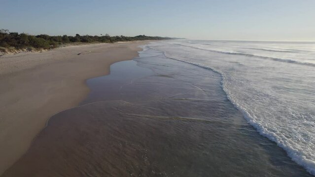 Surfer With Surfboard Walking In The Coolum Beach To Surf In The Early Morning On Sunshine Coast, QLD, Australia. - aerial