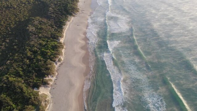 Coolum Beach And Wavy Ocean With Sea Fog During Sunrise In QLD, Australia. - aerial pullback