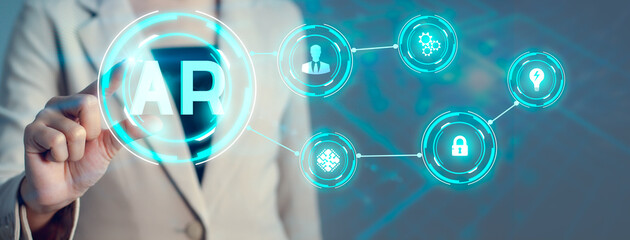 Businesswoman in cream suit connecting AR technology. Augmented reality blue icon. futuristic technology background.