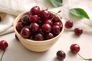 Bowl with sweet cherries on white background