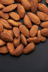 Whole shelled almond nuts kernels studio background