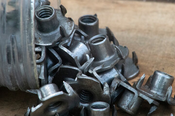 T nut, tee nut, blind nut, flush fitting, pronged nut, used to mount materials to a work piece leaving a flush surface, woodworking, joint