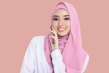 Close up young beautiful muslim woman with hijab isolated on pink background studio shot,...