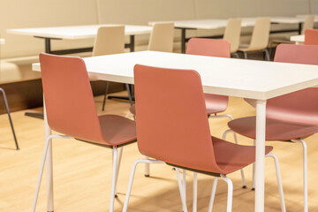 Inside a restaurant with white tables and chairs