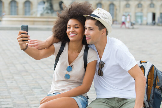 young hipster couple taking selfie while on city break