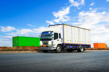 Fototapeta na wymiar Cargo Truck Driving on The Road with Blue Sky. Shipping Container Commercial Truck Transport. Delivery. Diesel Trucks, Lorry, Freight Trucks Logistics Cargo Transport 