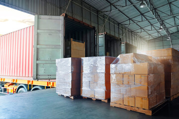 Package Boxes Wrapped Plastic Stacked on Pallets Load into Cargo Container. Trucks Loading Dock Warehouse. Supply Chain Shipment Supplies. Freight Truck Logistic, Cargo Transport Shipping