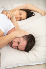 man cannot sleep because woman snoring