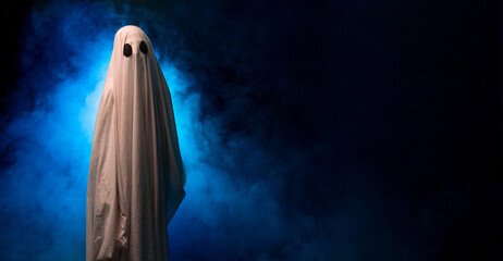Ghost looking at the camera while standing on a black background with smoke