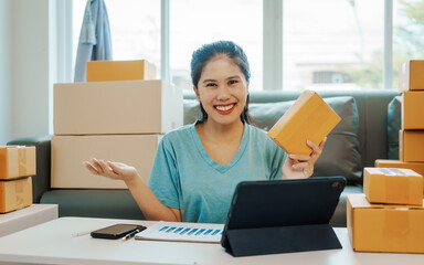 Looking camera, Asian woman holding SME package box and hands using smartphone to receive online email order, chat box message, SME sellers, concept, e-commerce team, online sales.