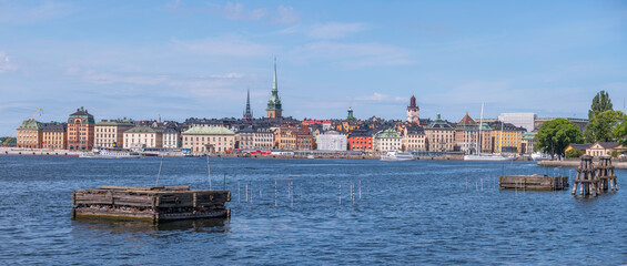Fototapeta premium Panorama, view over the old town Gamla Stan, anchor platform in the bay Strömmen, a sunny summer morning in Stockholm