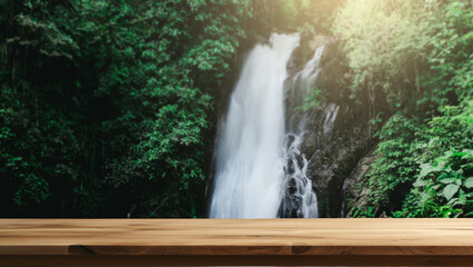 Empty wooden table with the natural background of tropical forest and waterfall. can be used to...