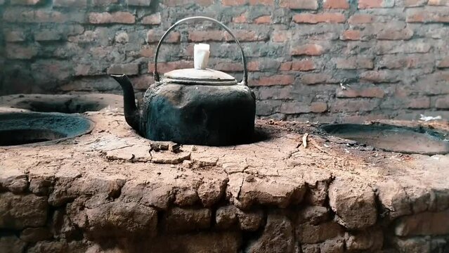 Aesthetic traditional kitchen with old clay stove and kettle