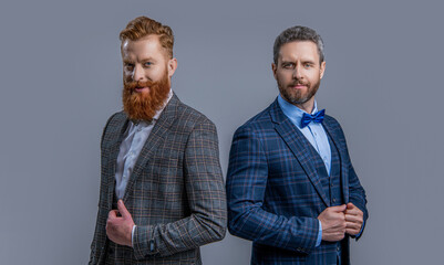 adult men in tuxedo at studio. men in tuxedo on background. photo of men in tuxedo suits