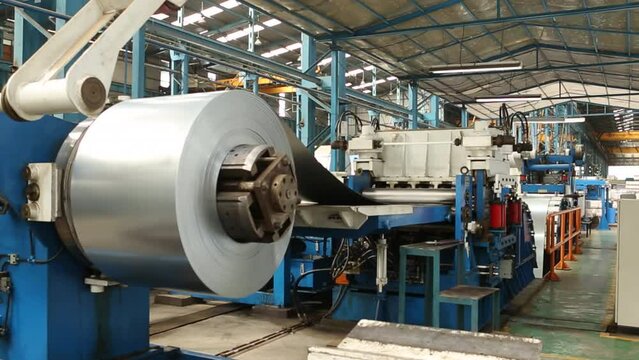 Metal or steel sheet cutting in a automated cutting machine in factory.