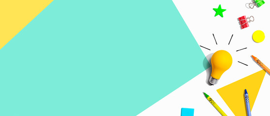 Idea light bulb with school supplies overhead view - flat lay