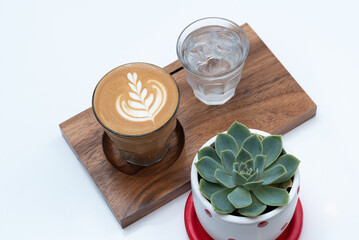 Cafe latte on a wooden plate