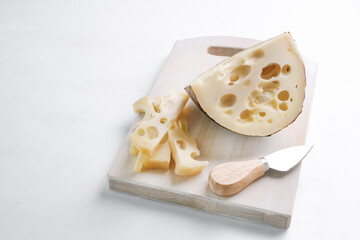 Emmental cheese triangle, Swiss cheese, isolated on white background. High resolution image