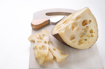 Emmental cheese triangle, Swiss cheese, isolated on white background. High resolution image