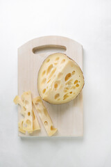 Emmental cheese triangle, Swiss cheese, isolated on white background. High resolution image