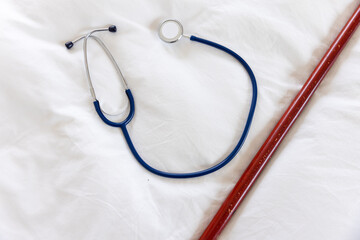 Overhead view of stethoscope on white bedding