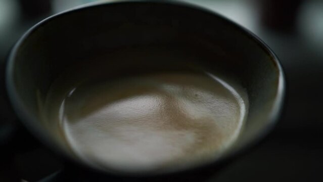 Close-up of coffee in cup, slow motion video. Coffee break, fika concept