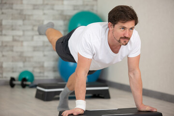 handsome athletic man doing plank exercise