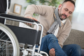 man on wheelchair trying to move independently