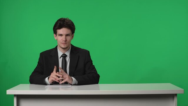 Anchorman on green screen background. The end of the news release, the man finishes the report, the studio plunges into darkness, the man leaves. Advertising area, workspace mock up.
