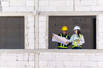 Progressive Construction Project Management with Engineers and Tablets - Blueprint Planning and On-Site Expertise