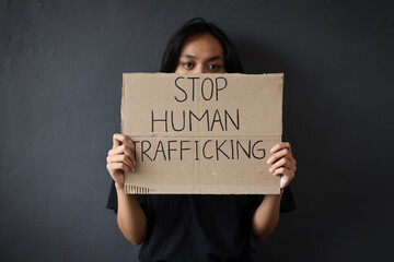 Stop Human Trafficking. Woman holding a board with Stop Human Trafficking text campaign.