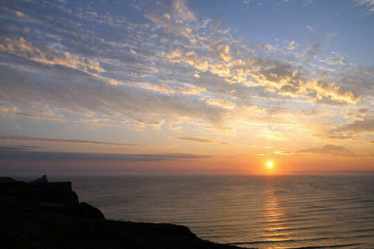 Beautiful sunset at Rhossili Bay on the western most point of Gower Peninsular looking towards Worm's Head.
