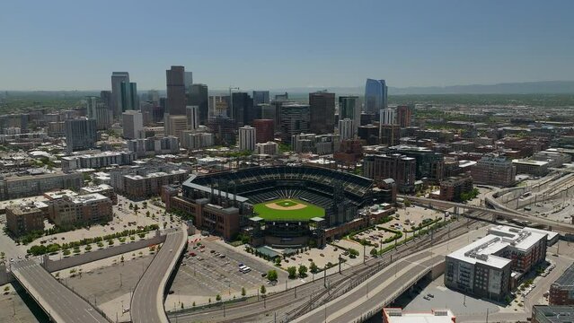Downtown Denver Coors field Colorado Rockies baseball stadium Rocky Mountain landscape Mount Evans aerial drone cinematic foothills Colorado cars traffic spring summer backwards movement