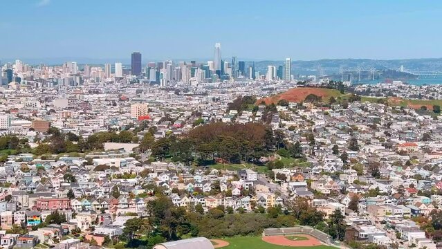 San Francisco neighborhood near Bernal Heights looking toward the city skyline - aerial flyover