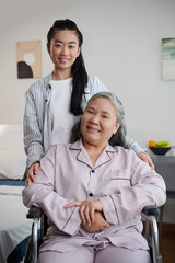 Portrait of smiling adult daughter taking care of senior mother