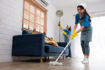 Close up of young woman cleaning floor with mop. Housework concept